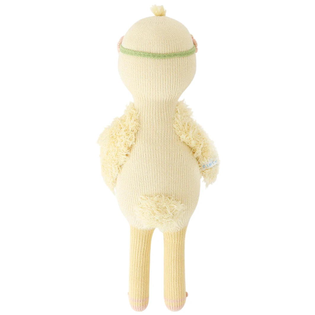 Flora the Duckling Mauve - Little 13" by Cuddle + Kind is a knitted mauve plush doll with a round head, small wings, tail, and long legs—perfect for spring adventures or daydreaming by a sparkling river.