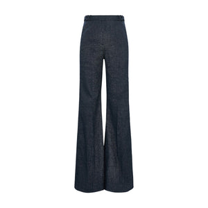 The Fluid Denim Pants by Dorothee Schumacher feature a high-waisted, wide-leg silhouette in dark denim with braided waistband detailing, evoking vintage suiting style, shown against a white background.