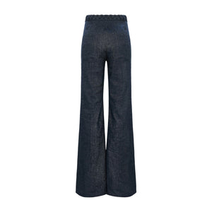 Fluid Denim Pants by Dorothee Schumacher in dark blue feature a wide-leg cut and braided waistband detailing, shown from the back against a white background.