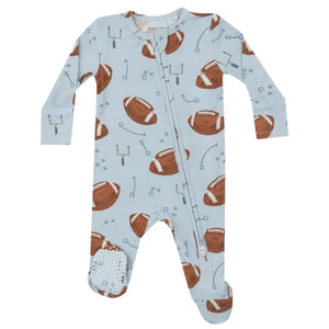 The Angel Dear Footballs Blue 2-Way Zip Footie by Angel Dear is a light blue baby onesie featuring brown footballs and play diagrams, crafted from soft bamboo fiber fabric, and includes cozy foot covers for extra warmth.