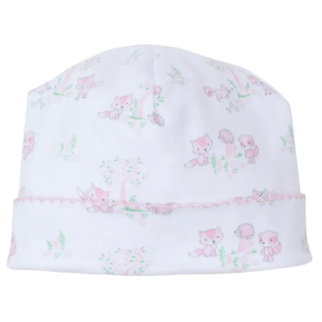 The Kissy Kissy Forest Fun Printed Hat, made from soft Pima cotton, showcases a charming pink forest fun design with foxes and hedgehogs among lively plants.