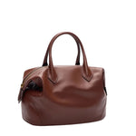 A small TWP Howard Bag, crafted from rich Cognac leather with a structured silhouette, features short handles and a zippered closure, displayed against a white background.