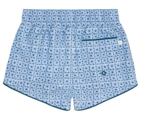 Minnow Boys' Starburst Boardie features a light blue geometric dark blue pattern, single back pocket with teal trim, elastic waistband, and comfy stretch liner.