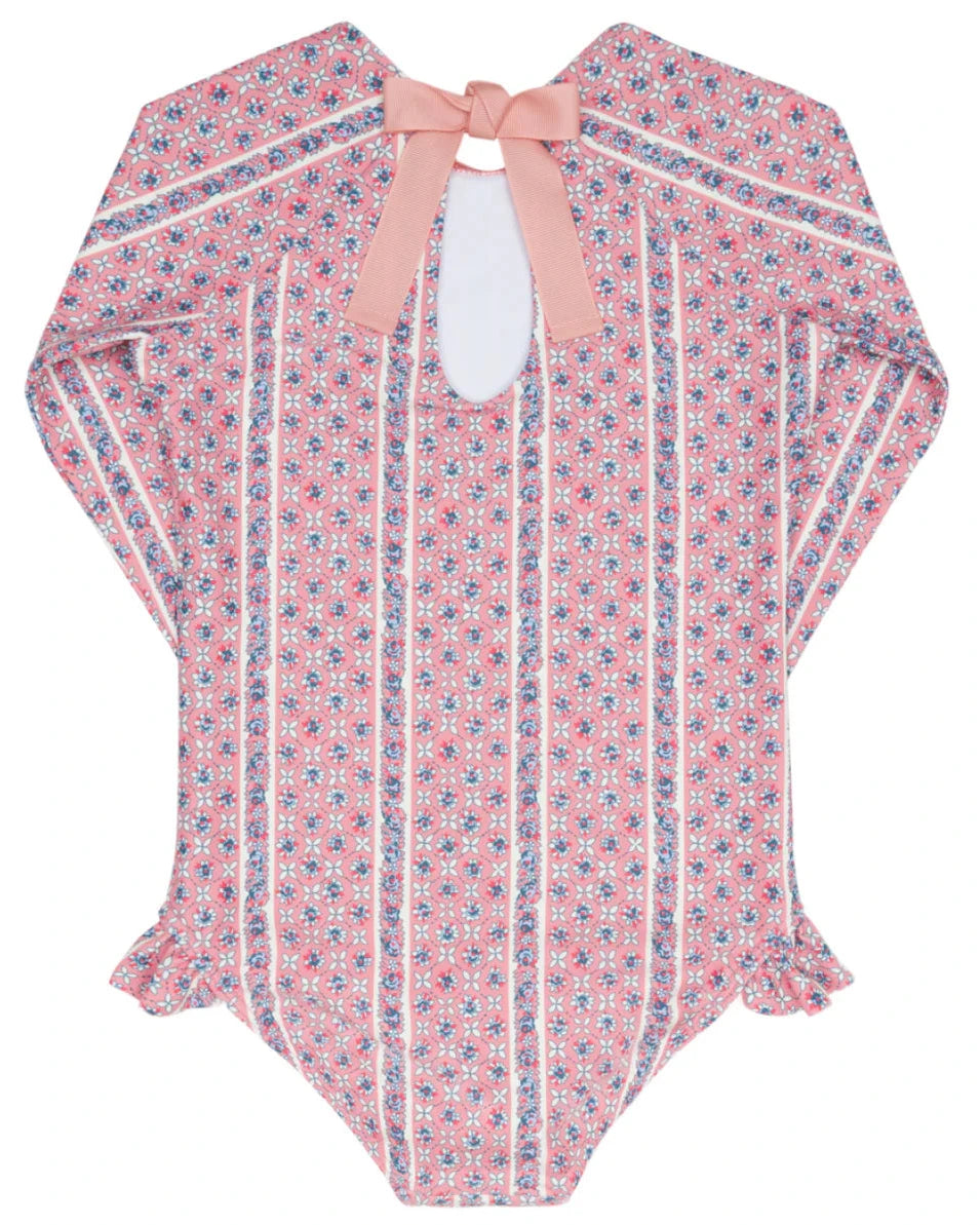 The Minnow Girls' Floral Tile Rashguard One Piece features long sleeves and a pink floral tile print—ideal as sun-safe swimwear or paired with your favorite girl's rashguard.