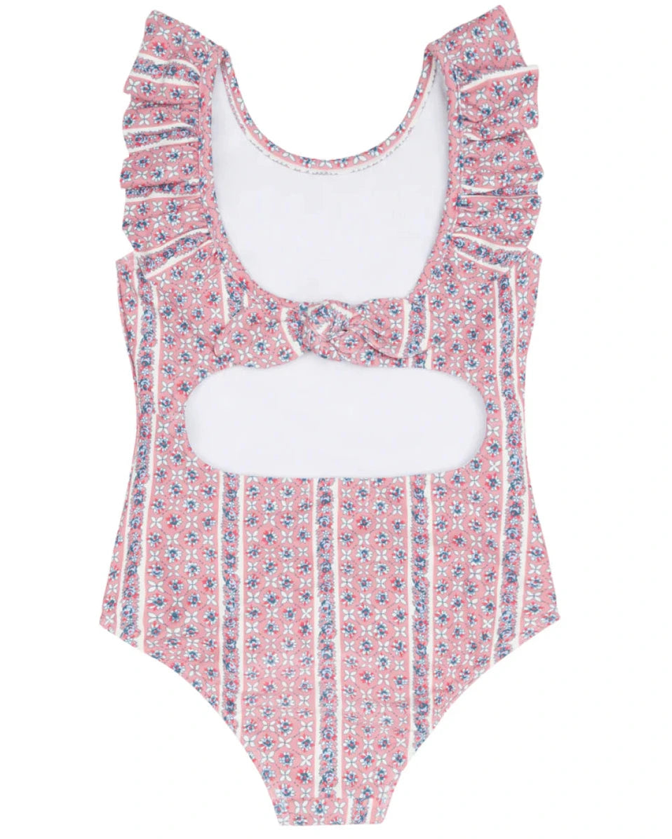 The Minnow Girls' Floral Tile Ruffle Collar One Piece features playful ruffles and a pink and white floral design, perfect for girls who love a stylish swimsuit.