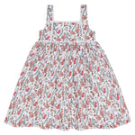 The Minnow Girls' Feathered Floral Square Neck Strap Dress features a full white skirt adorned with beautiful red flowers.