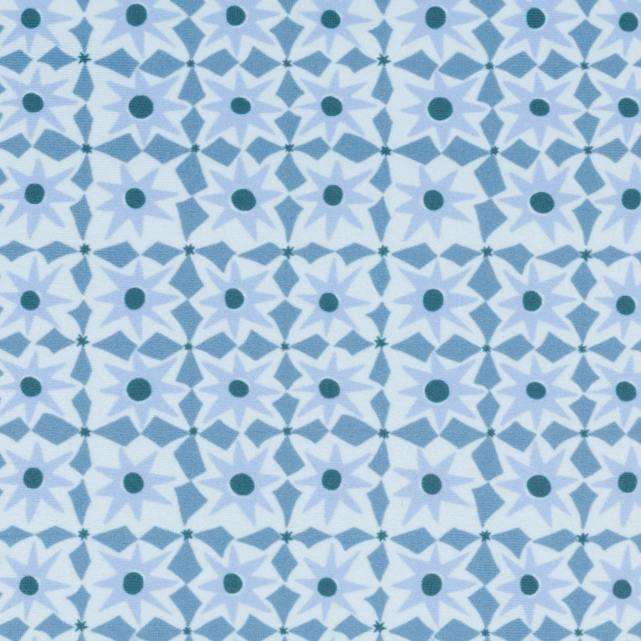 The Girls' Starburst Ruffle Strap One Piece by Minnow features a repeating geometric blue and white starburst pattern with dark blue centers on a light blue background, ideal for stylish resort swimwear.