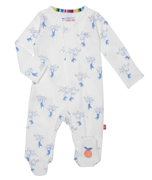 The Magnetic Me Love our Friend-Chimp Footie by Magnetic Me is a white baby onesie featuring a delightful blue floral and bird pattern. Made from GOTS certified organic cotton, it boasts long sleeves, enclosed feet, and a convenient front zipper. A small orange patch on the ankle adds a charming touch, making it an essential piece for any baby's wardrobe.