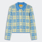 The Fringe Plaid Elle Shirt by Guest in Residence is a long-sleeve button-up cardigan with a blue and yellow plaid pattern reminiscent of a classic plaid shirt, featuring a blue collar and front buttons, laid flat on a light background.