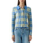 A woman wears the Guest in Residence Fringe Plaid Elle Shirt—a blue and yellow plaid button-up with a classic blue collar—paired with light blue jeans, styled with effortless western-inspired charm as she faces forward against a white background.
