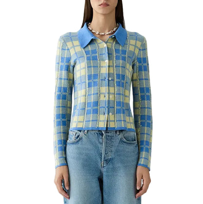 A woman wears the Guest in Residence Fringe Plaid Elle Shirt—a blue and yellow plaid button-up with a classic blue collar—paired with light blue jeans, styled with effortless western-inspired charm as she faces forward against a white background.