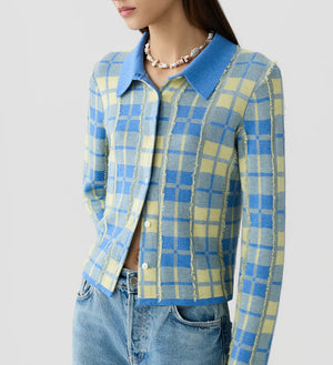 Woman wearing the Fringe Plaid Elle Shirt by Guest in Residence—a blue and yellow plaid button-up with a large collar—paired with light blue jeans and finished with a shell necklace for a touch of Western-inspired style.