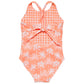 The Snapper Rock Girls' Cali Palms Recycled X Back Swimsuit features a peach and white grid print, a palm motif, a back bow, and stylish X-back straps.
