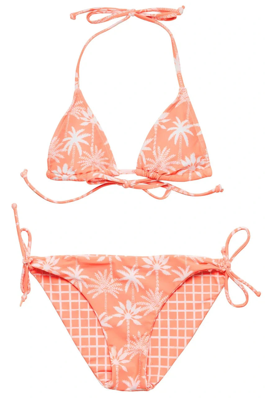 The Girls' Cali Palms Teen Recycled Triangle Bikini by Snapper Rock features a coral hue with white palm tree and grid prints, plus a string triangle top and tie-side bottoms—perfect for a stylish beach look.