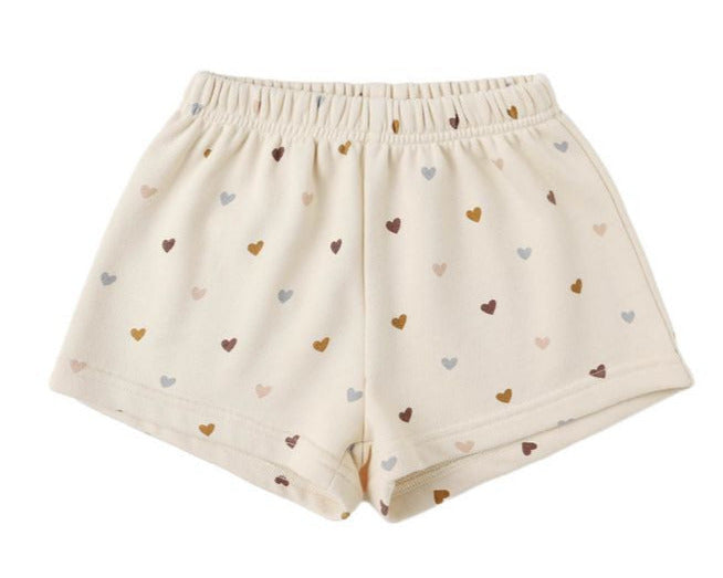 Rylee & Cru Girls' Track Short: comfy beige French terry shorts with an elastic waist and an all-over multicolored heart pattern.