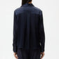 Someone wearing the TWP Joey Silk Shirt, a long-sleeve dark navy classic-fit top, paired with matching pants, shown from the back against a plain white background.