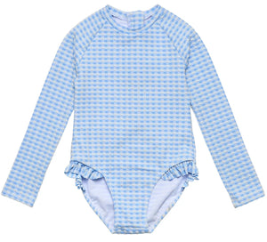 The Girls' Seaside Gingham Leg Frill Surf Suit by Snapper Rock is a long-sleeve one-piece with light blue and white checks, leg ruffles, and UPF50+ sun protection.