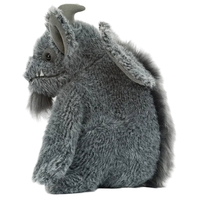 The Jellycat Growlston Gargoyle is a gray, fuzzy plush toy creature featuring a horn, large ears, and fangs. It is shown sitting upright and facing left against a white background.