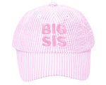 The Bits & Bows Big Sis Bow Baseball Hat features pink and white seersucker fabric with "BIG SIS" embroidered in pink—making it a charming gift for any big sister.