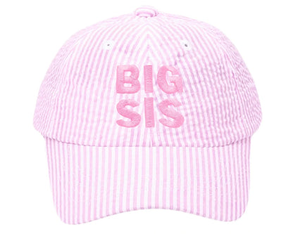 The Bits & Bows Big Sis Bow Baseball Hat features pink and white seersucker fabric with "BIG SIS" embroidered in pink—making it a charming gift for any big sister.