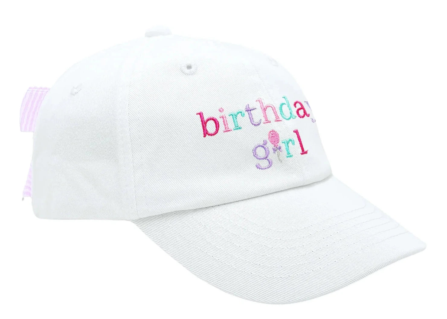 The Birthday Girl Bow Baseball Hat by Bits & Bows features "birthday girl" embroidered in colorful letters, a pink-striped adjustable strap, and a seersucker bow at the back.