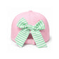 Introducing the Dog Golf Cart Bow Hat by Bits & Bows: a playful pink baseball hat with an adjustable strap, featuring a large green and white striped bow on the back. This stylish sun protection accessory is perfect for kids who love fun fashion on and off the golf course.