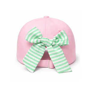 Introducing the Dog Golf Cart Bow Hat by Bits & Bows: a playful pink baseball hat with an adjustable strap, featuring a large green and white striped bow on the back. This stylish sun protection accessory is perfect for kids who love fun fashion on and off the golf course.
