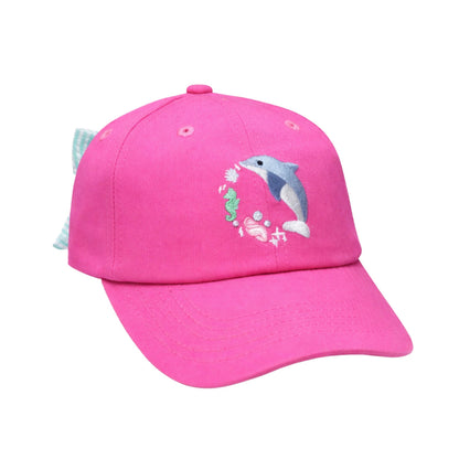The Bits & Bows Dolphin Daydream Bow Hat is a bright pink kids’ sun hat featuring an embroidered dolphin, seaweed, and seashells on the front, with a charming blue and white seersucker bow attached at the back for a playful touch.