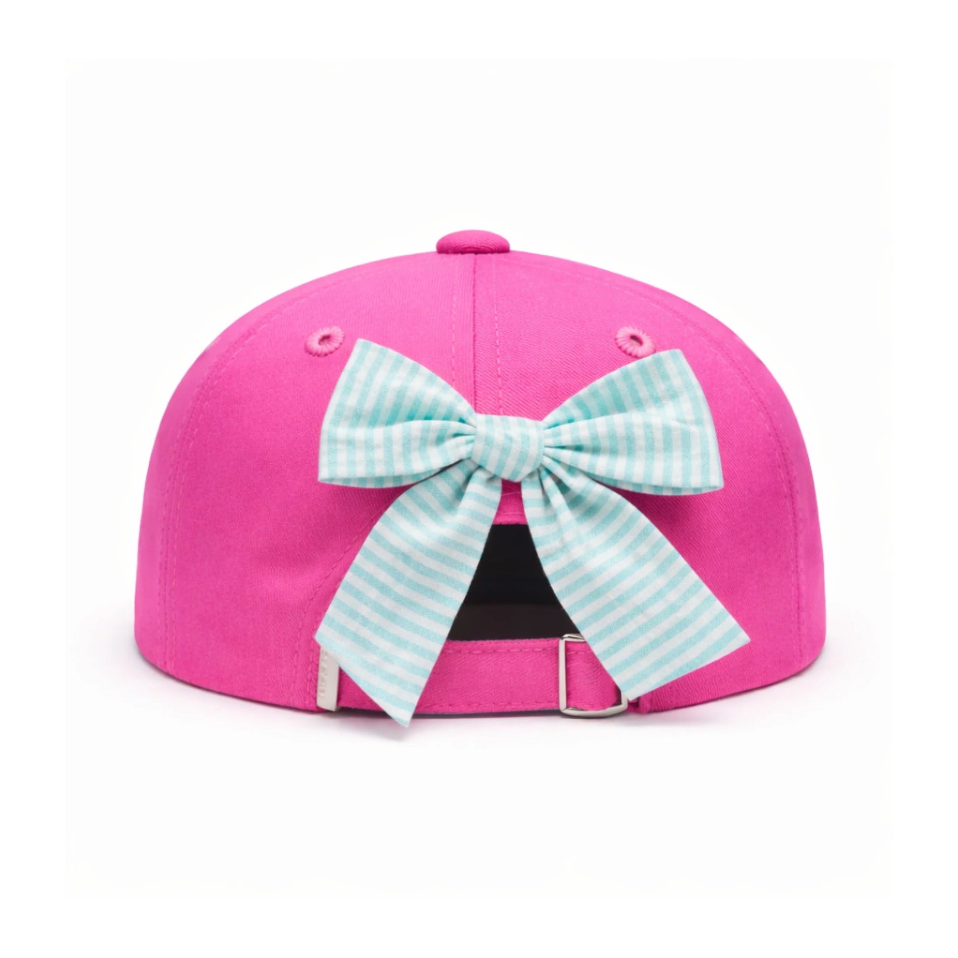 The Dolphin Daydream Bow Hat by Bits & Bows is a bright pink kids’ baseball cap, featuring a blue and white seersucker bow attached at the back, displayed on a white background.