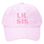 The Lil Sis Bow Baseball Hat by Bits & Bows features pink and white stripes, "LIL SIS" embroidery on the front, and a cute seersucker bow—perfect for adding charm to any little sister’s outfit.