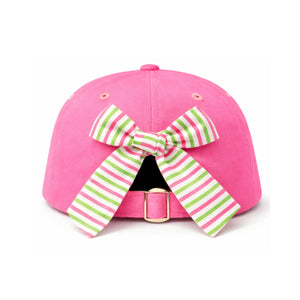 The Tee Time Bow Hat by Bits & Bows is a pink baseball cap featuring a green and pink striped bow above the adjustable strap at the back.