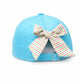 The Bits & Bows Turtle Bow Hat is a playful kids’ marine hat seen from the back, showcasing a fabric bow with pink, green, and white stripes above the adjustable strap—perfect for sunny adventures.
