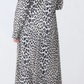 Person wearing the Callas Milano Genny Cheetah Shirtdress, styled with grey socks and brown high-heeled sandals, shown from the back against a plain background.