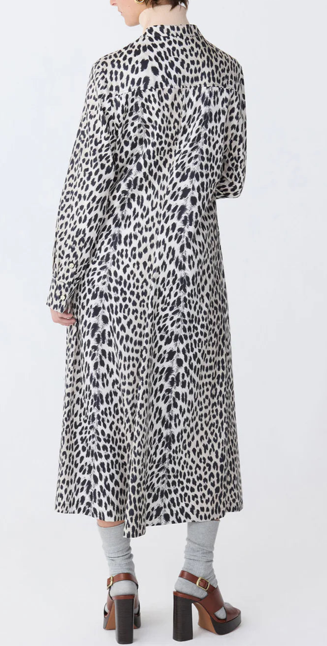 Person wearing the Callas Milano Genny Cheetah Shirtdress, styled with grey socks and brown high-heeled sandals, shown from the back against a plain background.