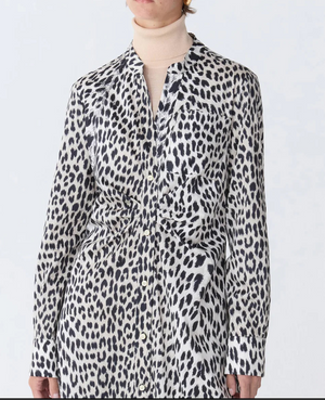 A person wearing the Genny Cheetah Shirtdress by Callas Milano over a beige turtleneck top.