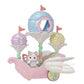 A petite white Latte Cat baby figurine with pink wings, wearing a delicate fairy costume, sits in the Calico Critters Floral Fantasy Skyship—a pastel-colored carriage featuring three flower-shaped seats and decorative flags.