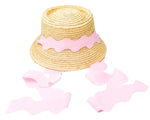 The Youth Harbor Hat by Bits & Bows features a wavy pink ribbon around the crown and two long matching ribbons, offering stylish sun protection—perfect for the beach.