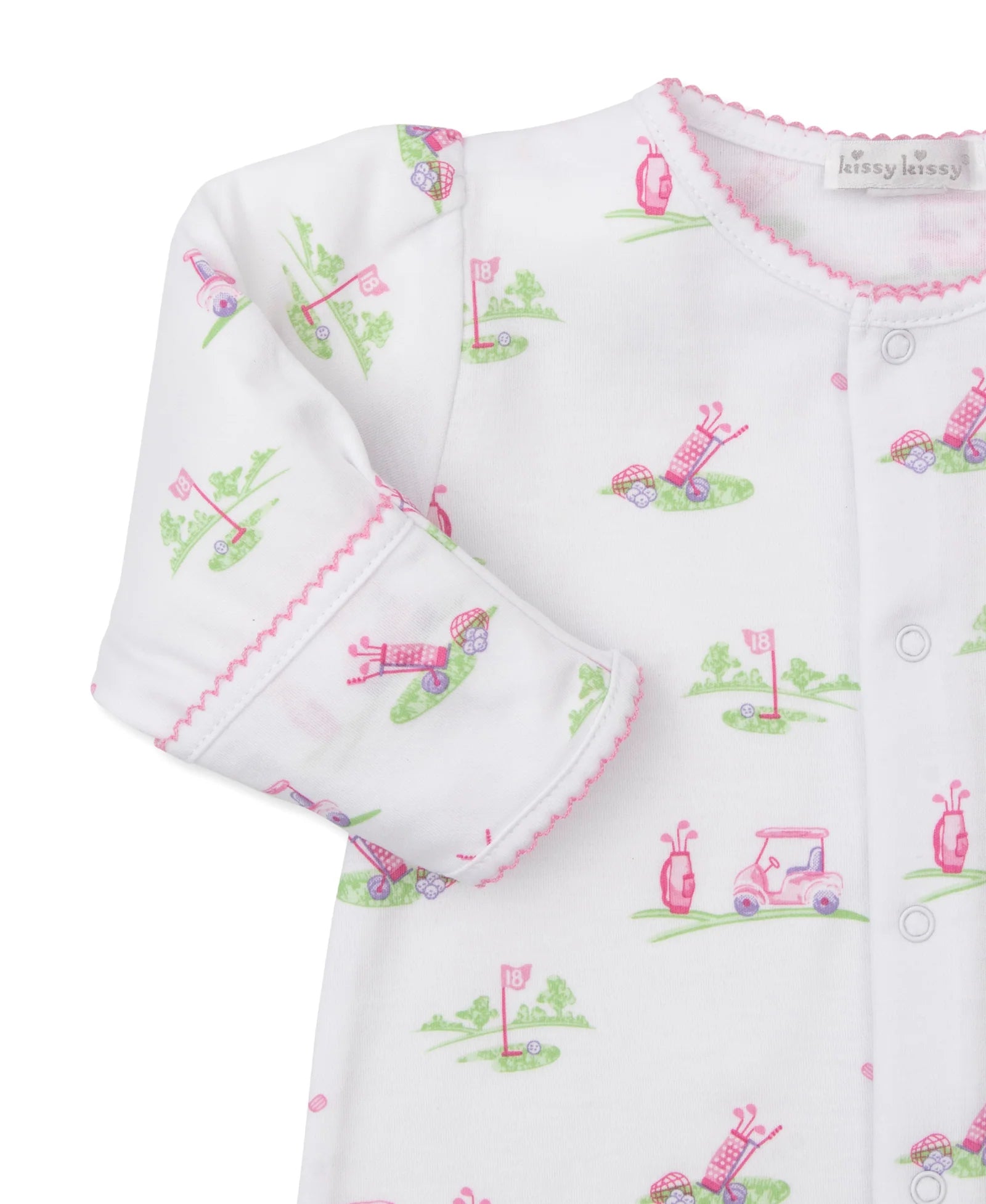 The Kissy Kissy Fairway Foursome Convertible Gown is a white onesie with pink trim, crafted from soft Pima cotton. It features a playful golf-themed pattern with snap buttons down the front, perfect for little golfers in training!.