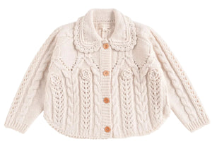 The Girls' Khellana Cape Sweater by Louise Misha is a cream-colored knitted cardigan featuring a delicate Peter Pan collar, cable knit pattern, and wooden buttons down the front.