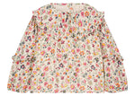 The Louise Misha Girls' Cleo Blouse is a long-sleeve cotton gauze top with ruffled collar and cuffs, decorated with a vibrant floral print on a light background.
