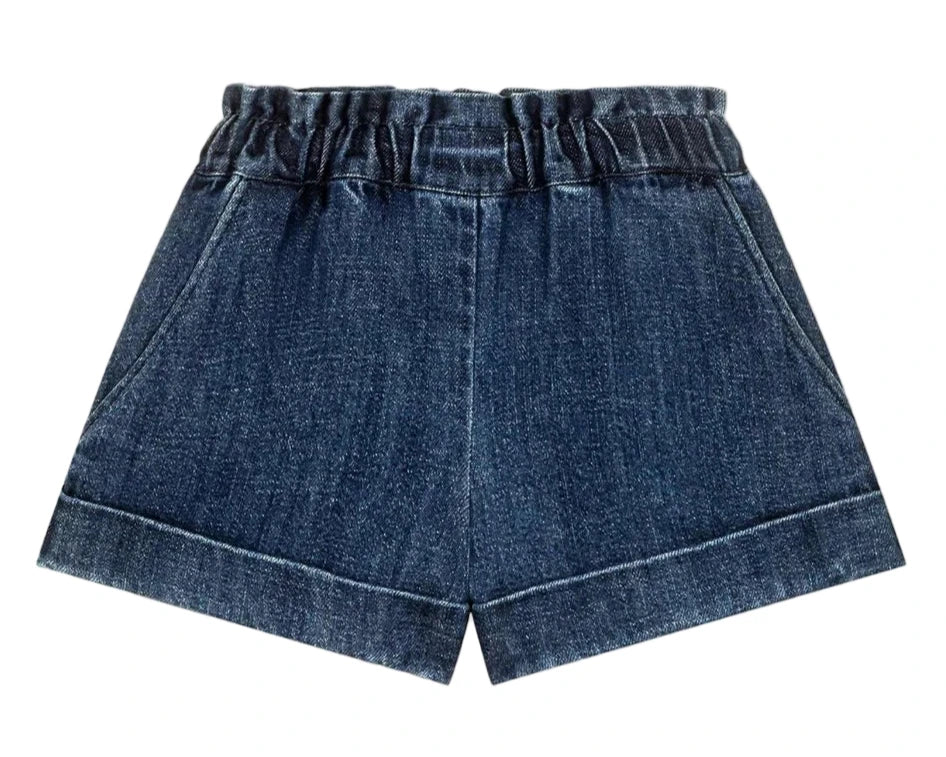 The Girls' Virgina Shorts by Louise Misha are dark blue denim with an elastic waist, side pockets, and a wide fit, shown against a white background.
