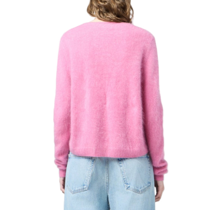 A person wearing the Grizzly Cashmere Cardigan by Guest in Residence and light blue jeans, shown from the back against a white background.