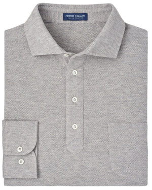 Folded Peter Millar Ramble Long-Sleeve Cotton Cashmere Polo in grey, featuring three buttons, a front chest pocket, and a collar. This luxurious men's polo is crafted from a cotton cashmere blend with the "Peter Millar" brand label visible inside the collar.