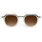 Front view of Krewe's Galvan Sunglasses, showcasing an innovative white frame and brown gradient lenses against a plain white background.