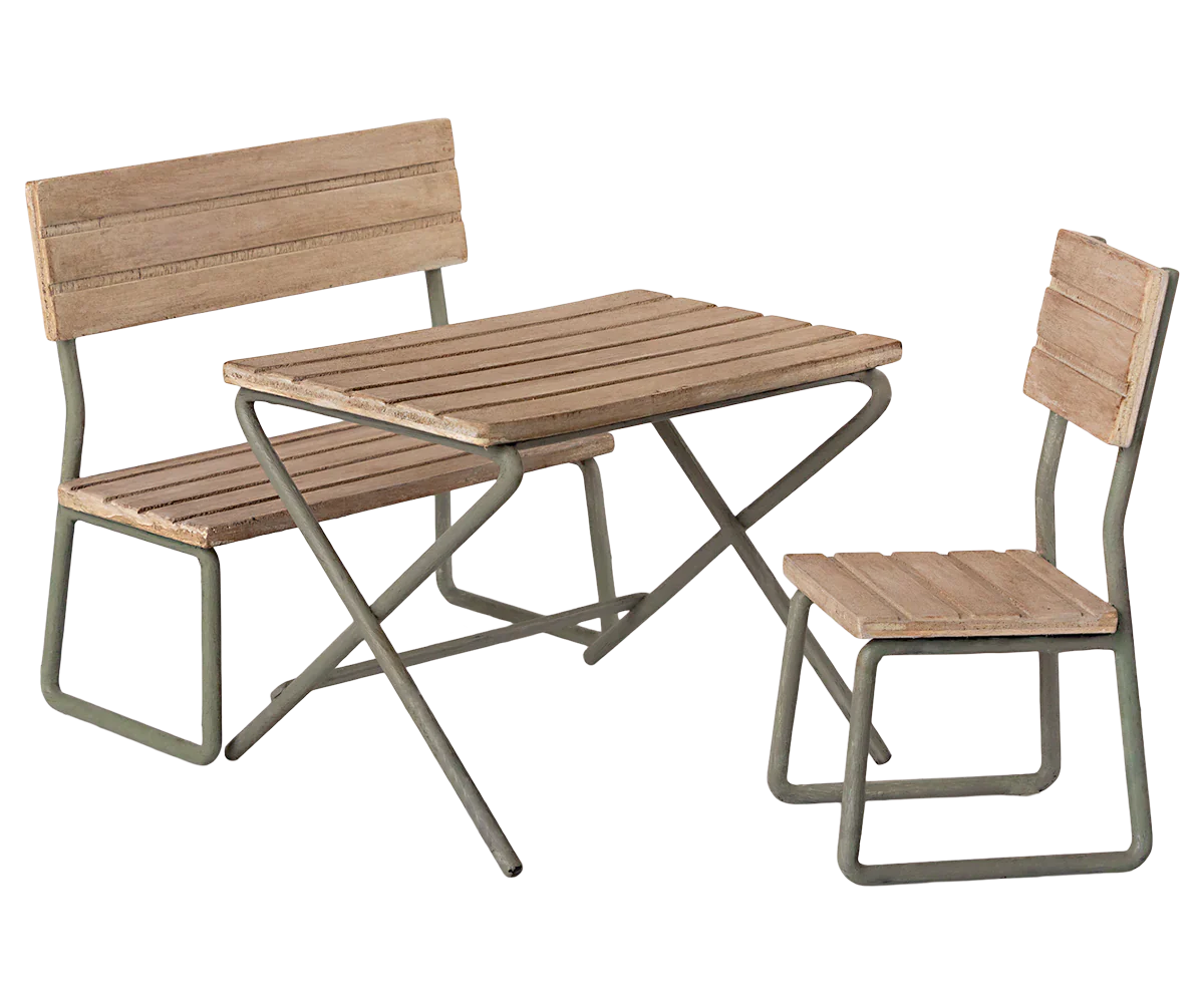 The Maileg Garden Set, Miniature by Maileg is a metal-framed wooden bench, chair, and table set designed for outdoor use. This vintage garden set is perfect patio furniture, made from FSC wood to ensure sustainability while enhancing your outdoor space with timeless charm.