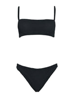 The Hunza G Gigi Bikini is a black crinkle fabric two-piece with a straight bandeau top, thin straps, and matching high-cut bottoms, shown on a white background. This one-size swimsuit blends comfort and modern style.
