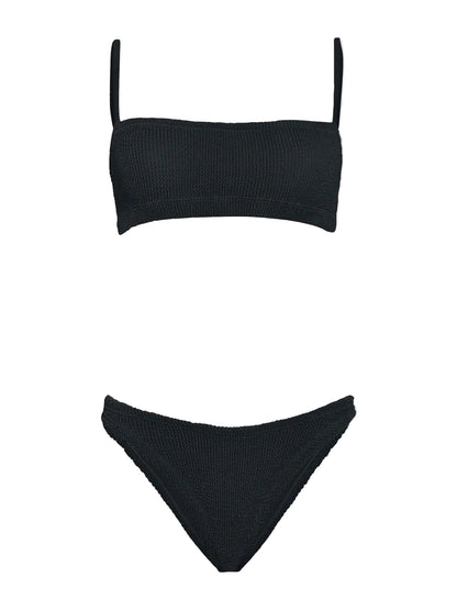 The Hunza G Gigi Bikini is a black crinkle fabric two-piece with a straight bandeau top, thin straps, and matching high-cut bottoms, shown on a white background. This one-size swimsuit blends comfort and modern style.