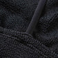 Close-up of the Gigi Bikini by Hunza G: black crinkle fabric with a raised, wavy pattern and a smooth, diagonal strap—ideal for a stylish one-size swimsuit look.
