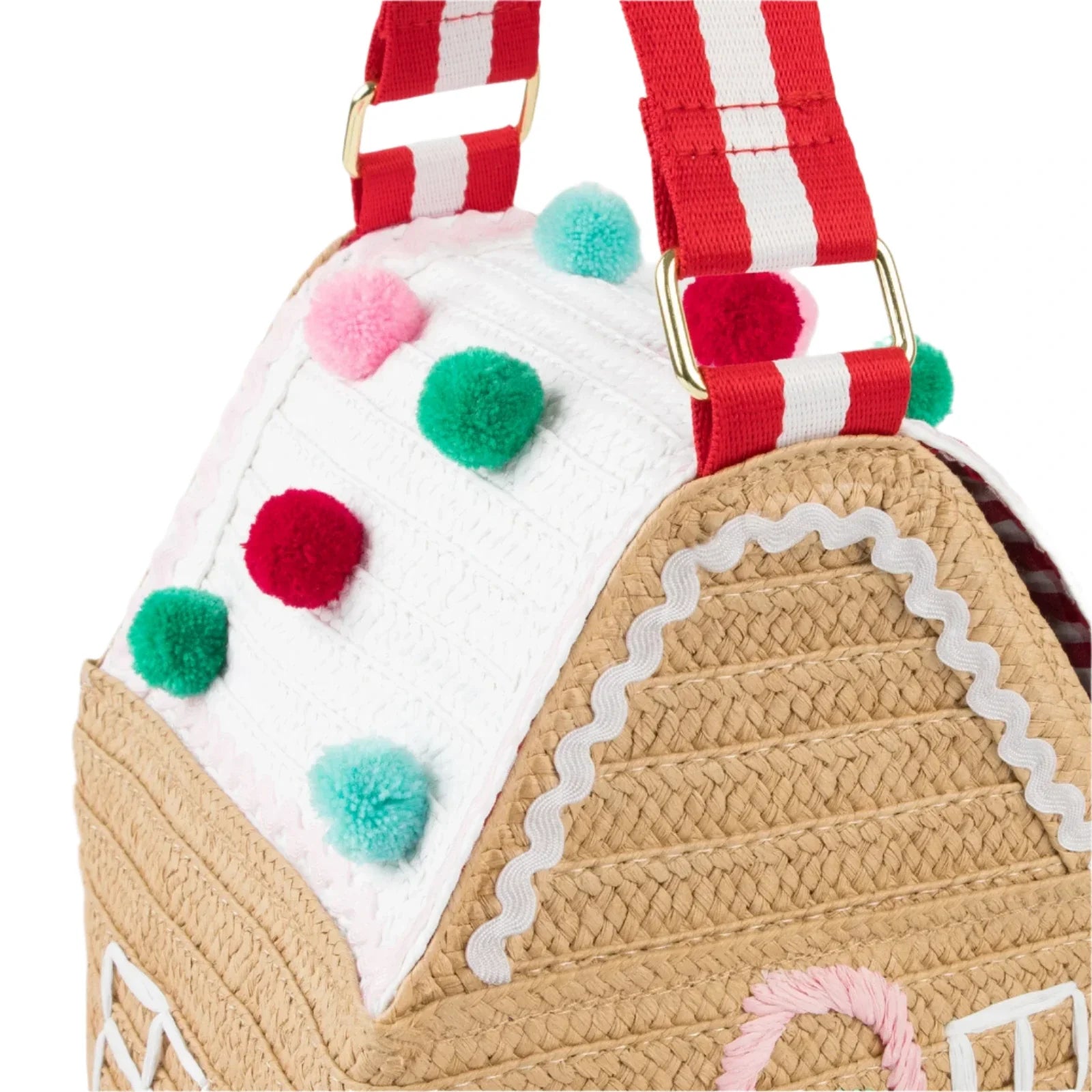 Close-up of the Meri Meri Gingerbread House Bag, showcasing vibrant pom-poms on the roof and red-and-white striped handles.