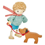 Mr. Goodwood and his Dog by Tender Leaf Toys is a solid wood figurine set featuring a child in a striped scarf and sweater holding a red leash, with their pet dog, beautifully crafted on a white background.